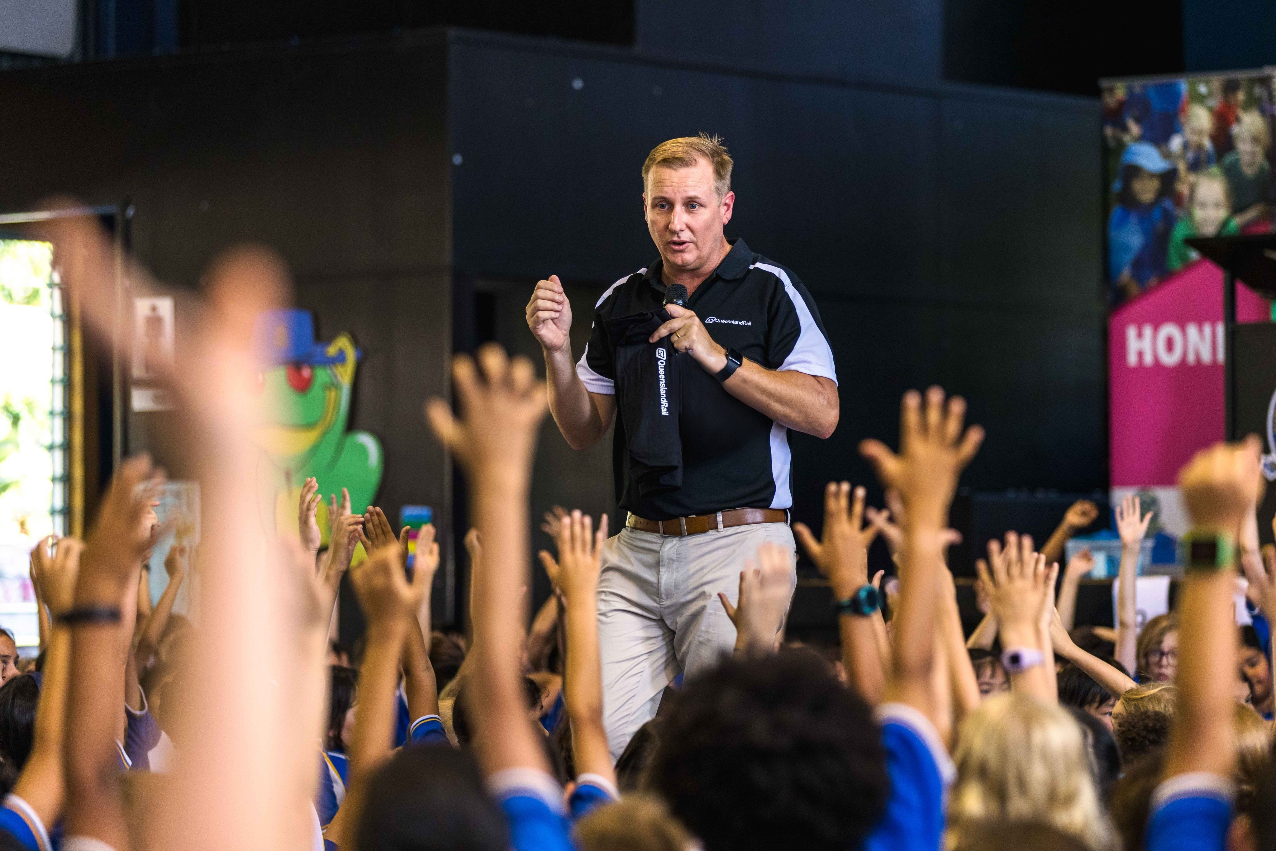 A Queensland Rail educator presenting to a group of school students