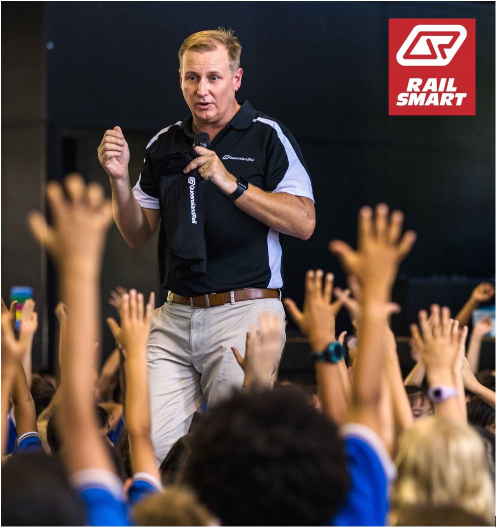 A Queensland Rail educator presenting to a group of school students