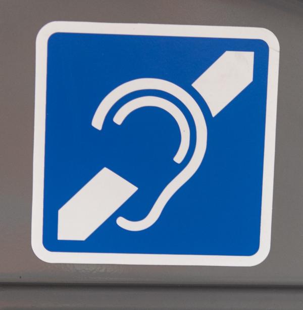 blue and white internationally recognised hearing loop signs