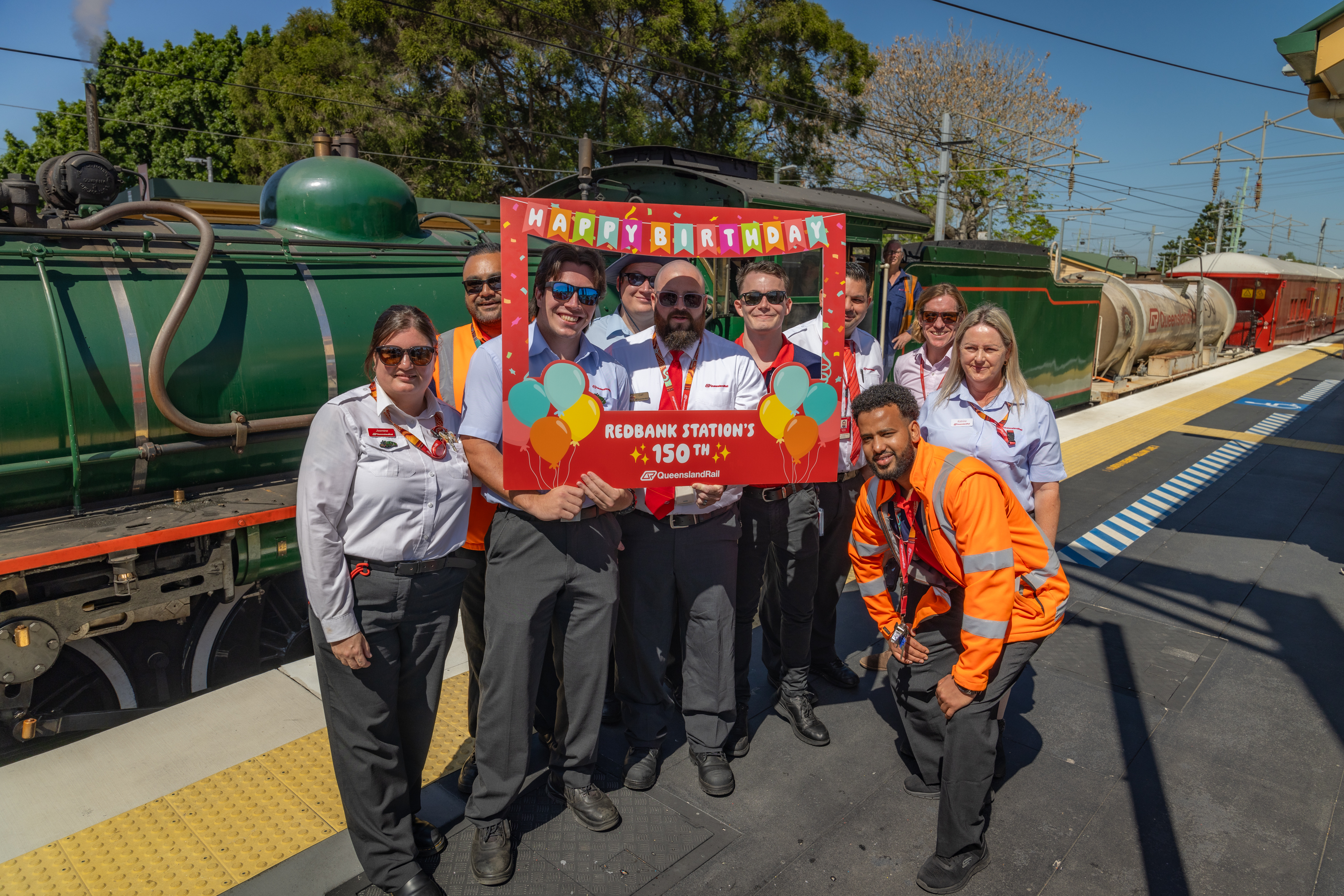 Redbank station staff standing in front of steam train